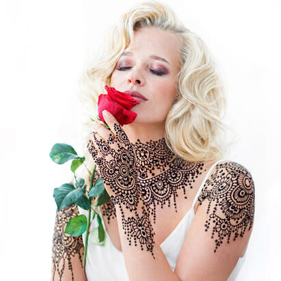 Portrait of Maggie Habieda holding a red rose for Colours of Love